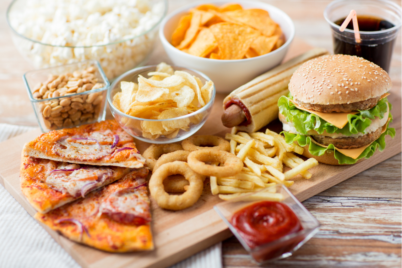 An image of unhealthy food such as burgers, fries, chips, pizza, etc.