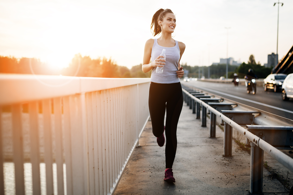 Woman running over bridge. 