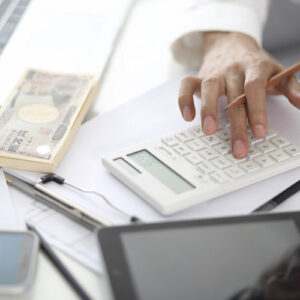 Midsection Of Man Working On Calculator