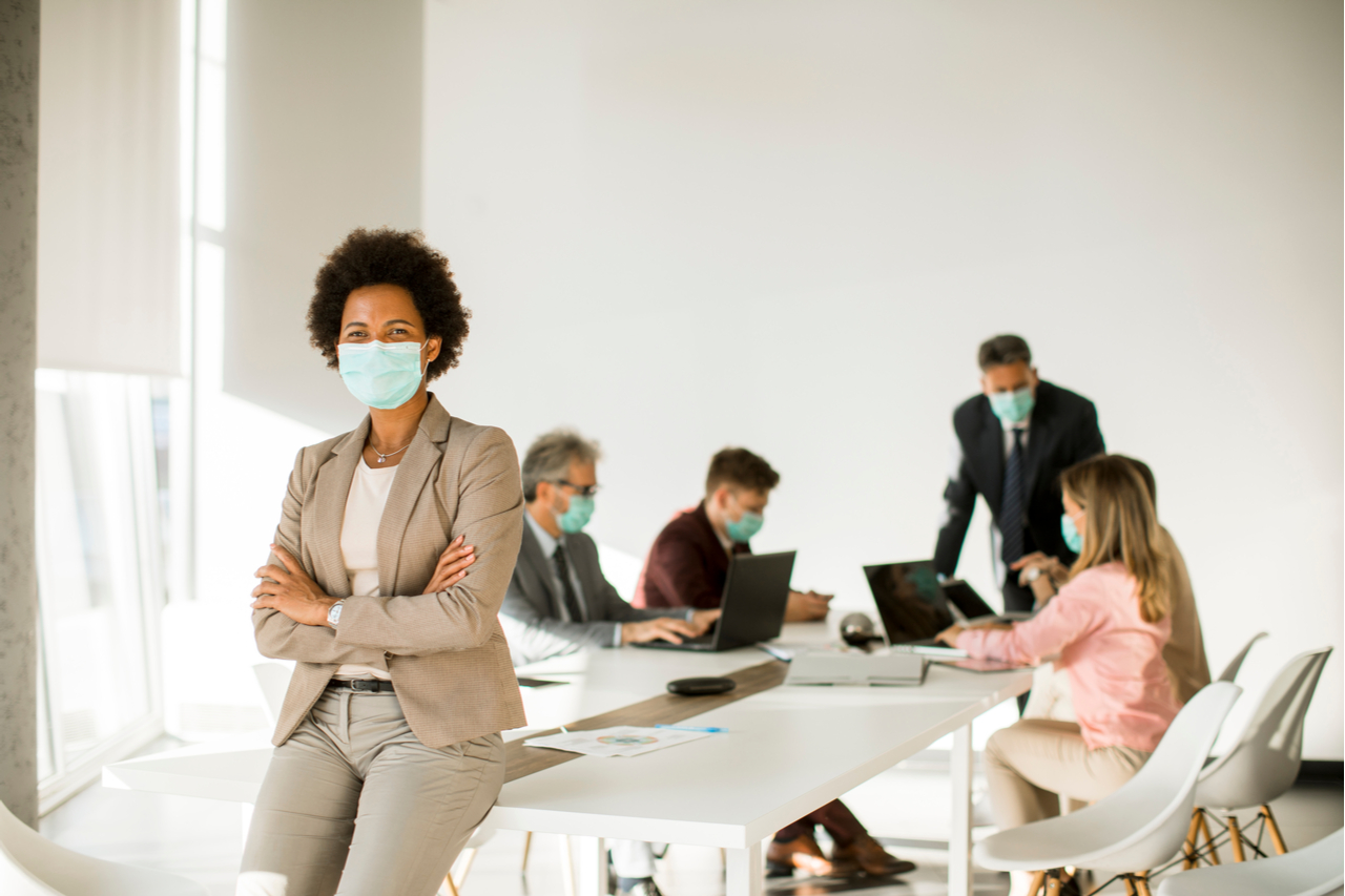 Woman in the office wear mask as protection from corona virus.