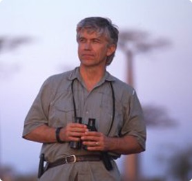 Russ Mittermeier holding binoculars.