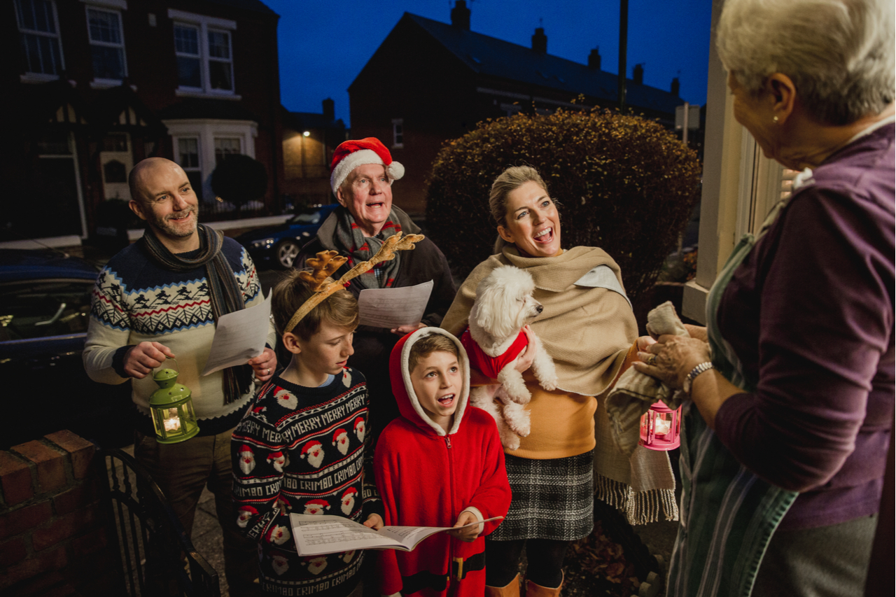 A lovely family doing door-to-door carol singing.