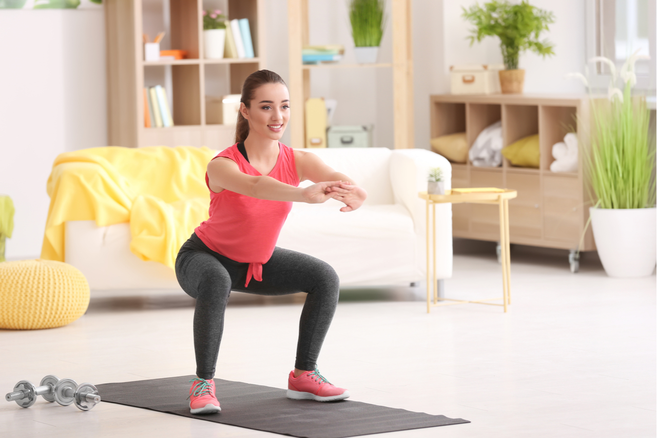 Young woman doing fitness exercise at home.