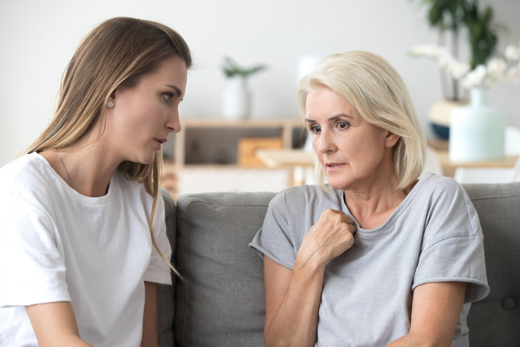 A mother and daughter having a serious conversation.