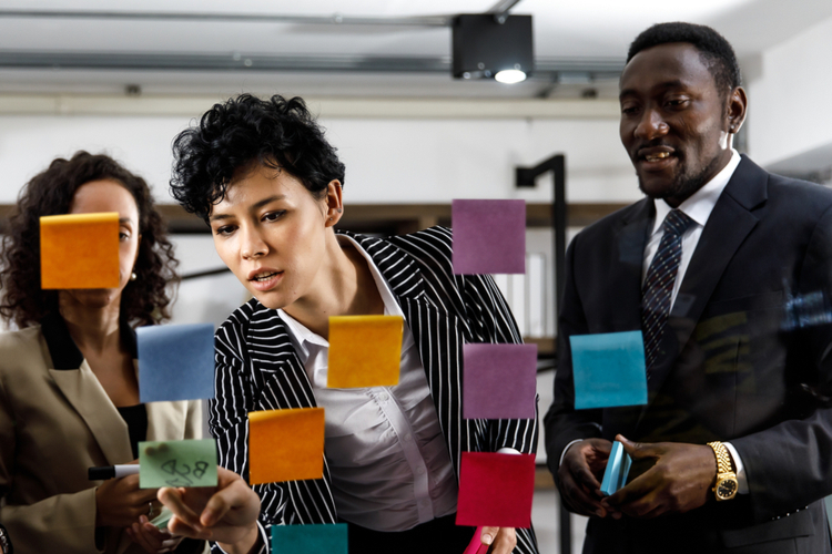 woman writing and brainstorming creative marketing ideas 