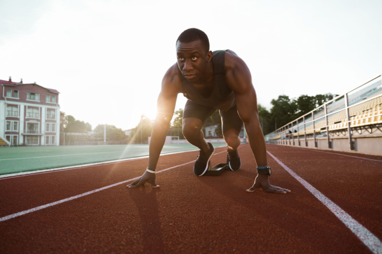 Confident sportsman standing in starting position 