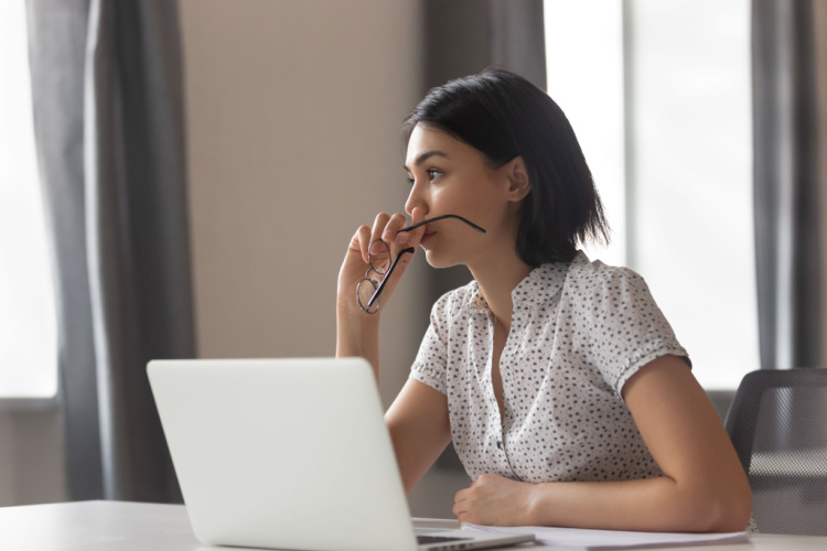 anxious business woman looking away thinking solving problem at work