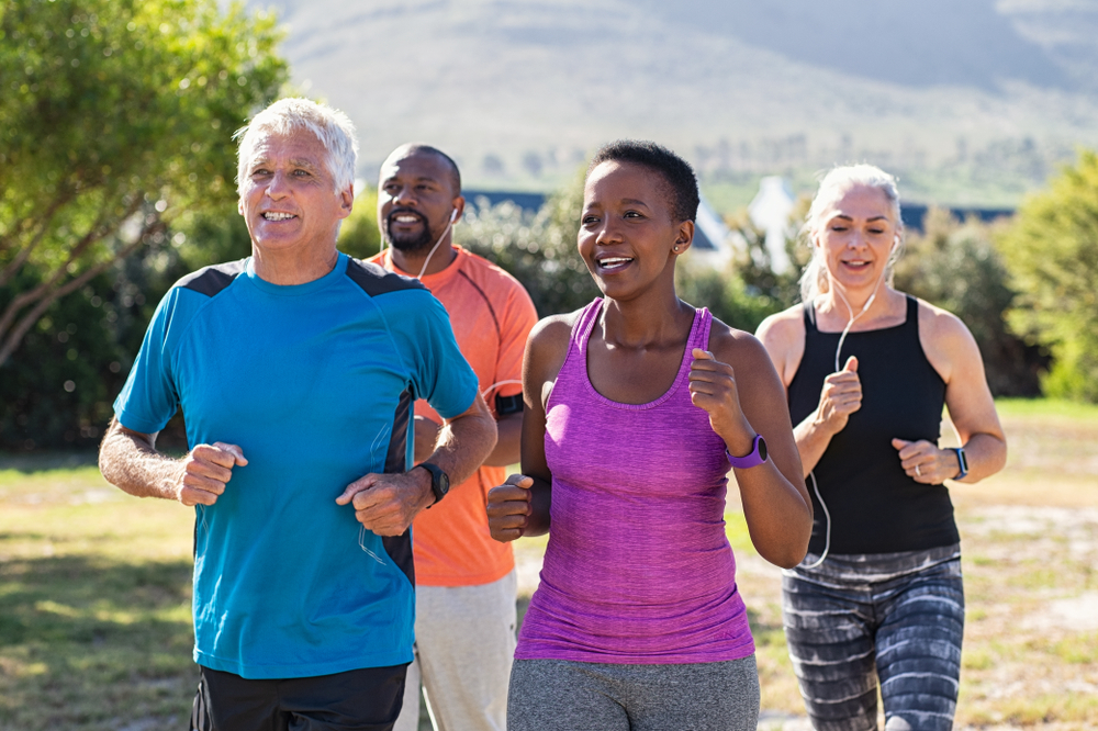 Group of healthy and mature people jogging