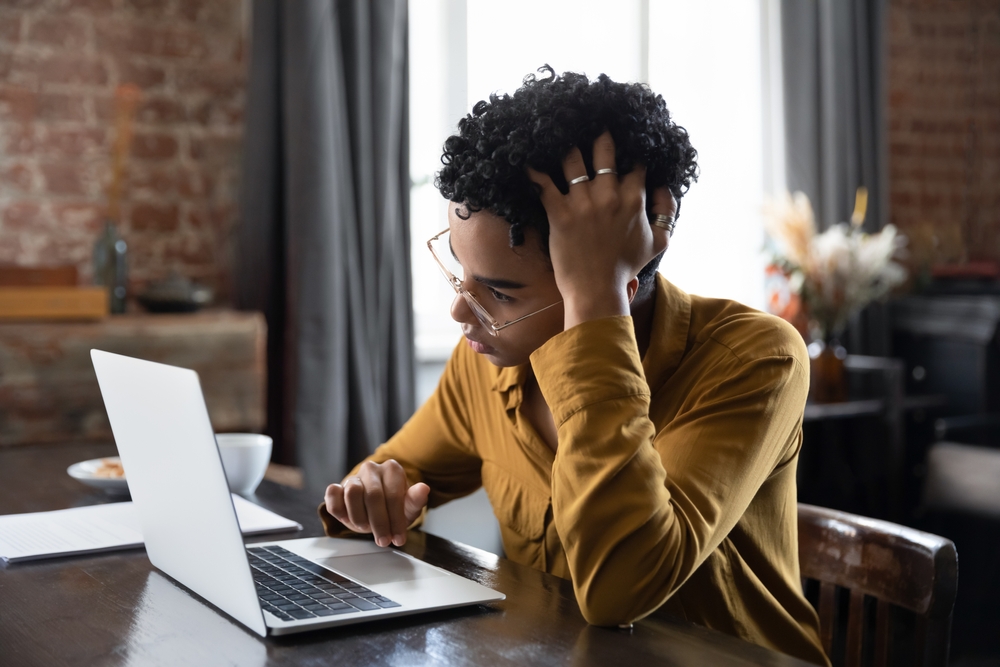 Woman in glasses looking at laptop screen