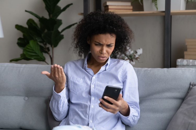 woman look at smartphone screen confused by news